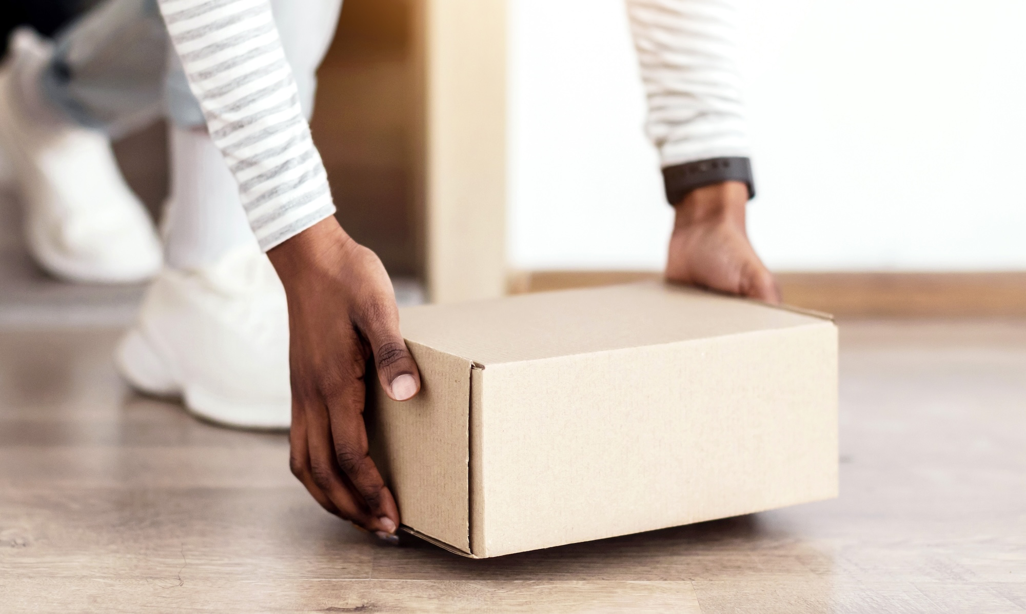 Person receiving a package at their front door